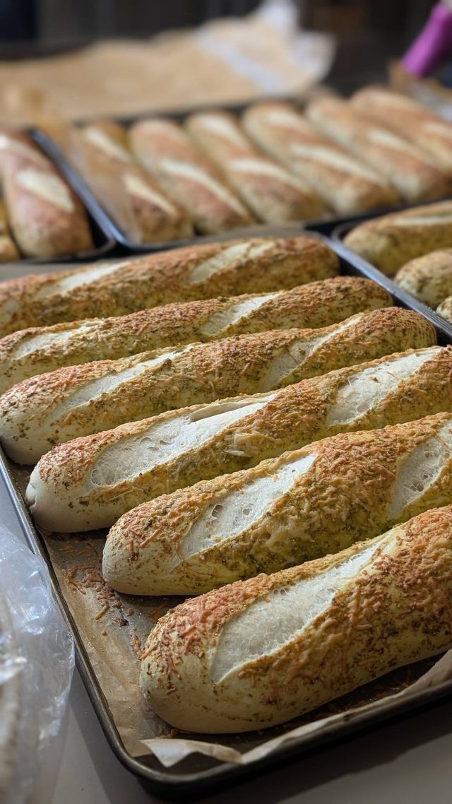 Long scored loaves on a baking tray