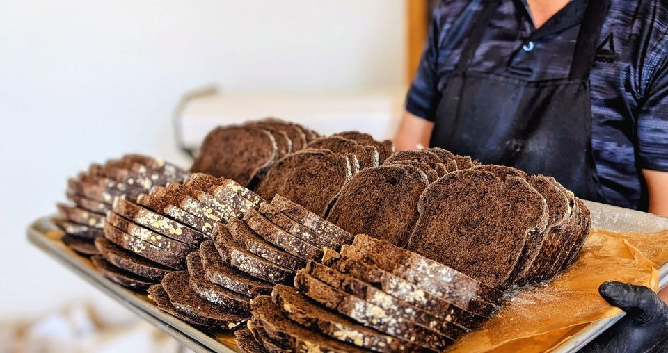 Sliced dark loaves laid out on a tray