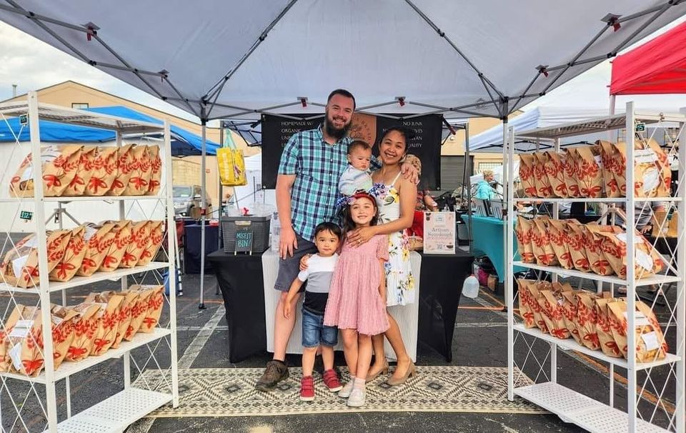 The Providence Bread family at our farmers market booth, with shelves of sourdough