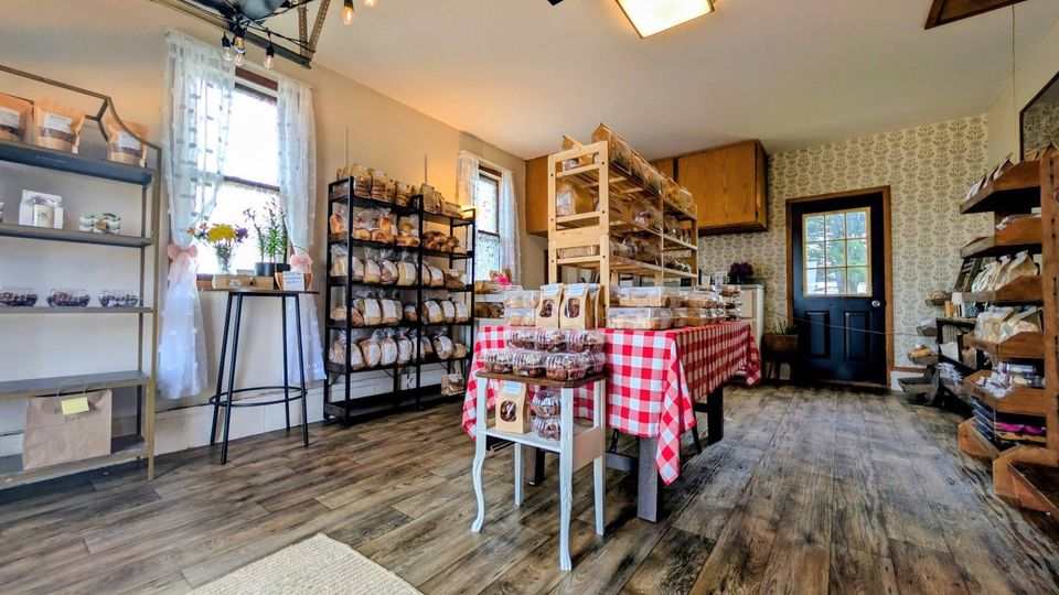 Inside our garage shop: bread shelves and a table with a red gingham cloth
